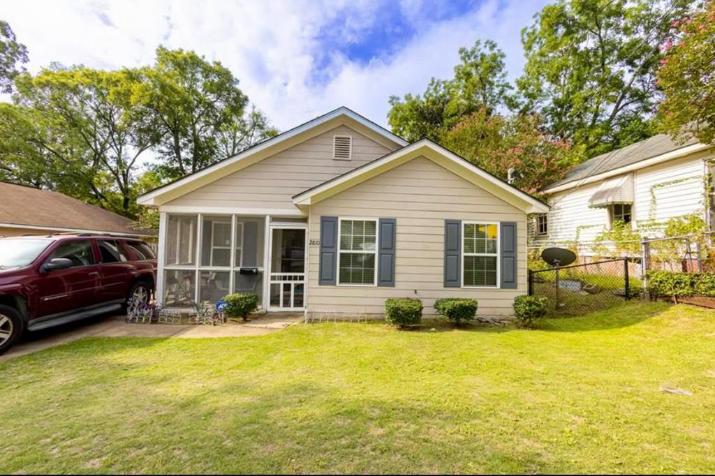 a front view of a house with a garden and porch