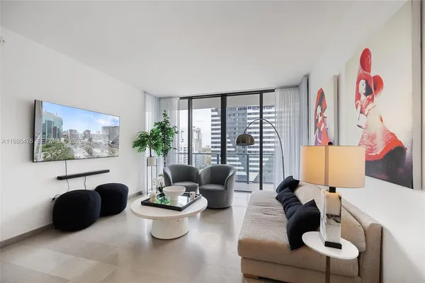 a living room with furniture and a large window