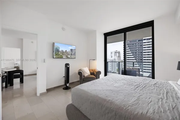 a bedroom with a large bed and a large window