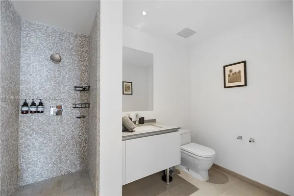 a bathroom with a toilet sink and shower