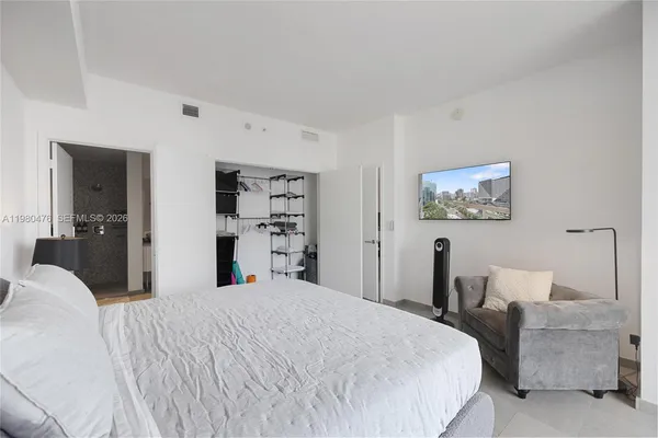 a bedroom with a bed and a couch