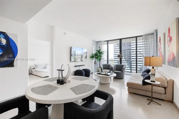 a living room with furniture and a large window