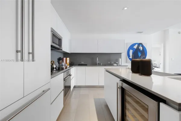 a kitchen with a sink cabinets and a stove top oven