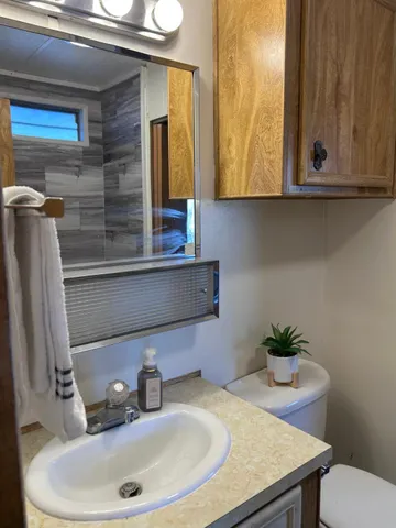 a bathroom with a sink a mirror and vanity