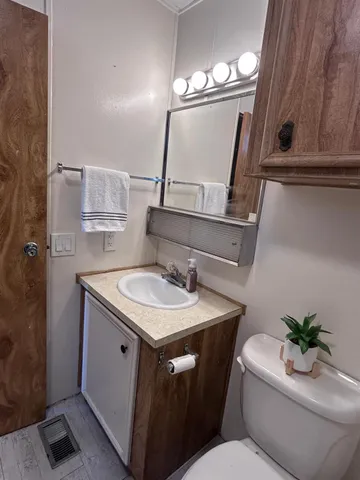 a bathroom with a toilet sink and mirror