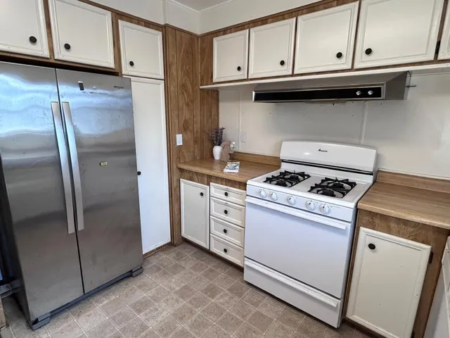 a kitchen with appliances and cabinets