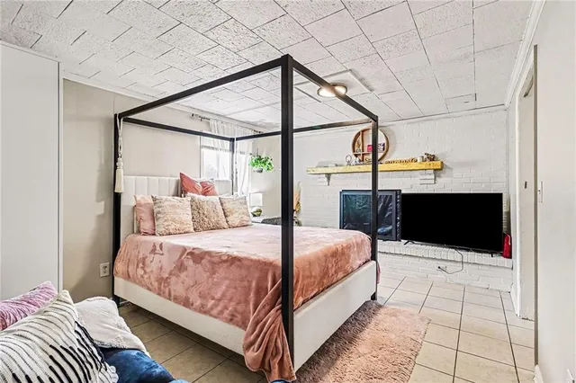 a bedroom with a bed and a flat tv screen