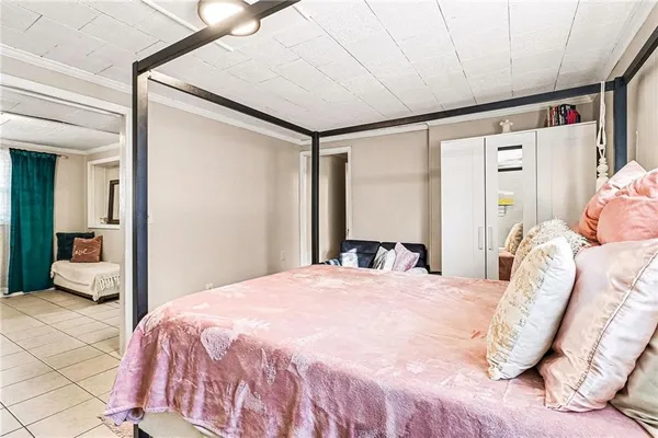 a bedroom with a bed and a large mirror