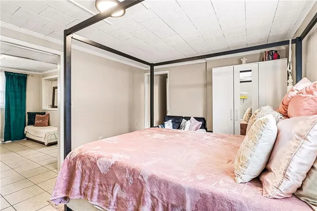a bedroom with a bed and a large mirror