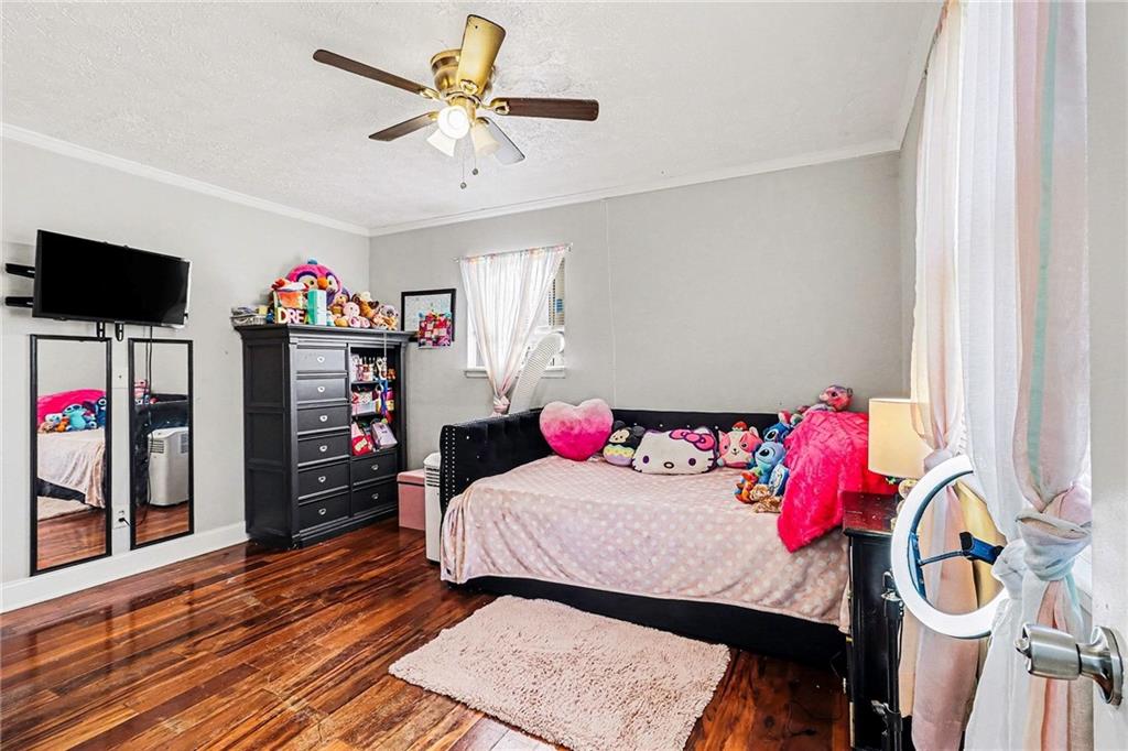 6186 Deans Way Morrow, GA 30260 - Photo 24 of 35 a bedroom with a bed and a flat screen tv