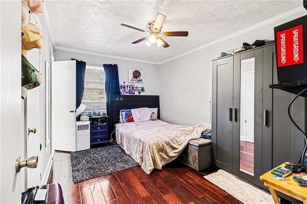 6186 Deans Way Morrow, GA 30260 - Photo 25 of 35 a bedroom with a bed and a flat screen tv