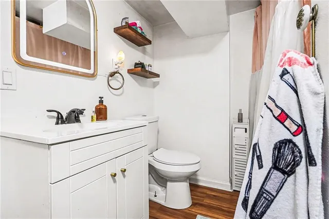 a bathroom with a sink toilet and shower
