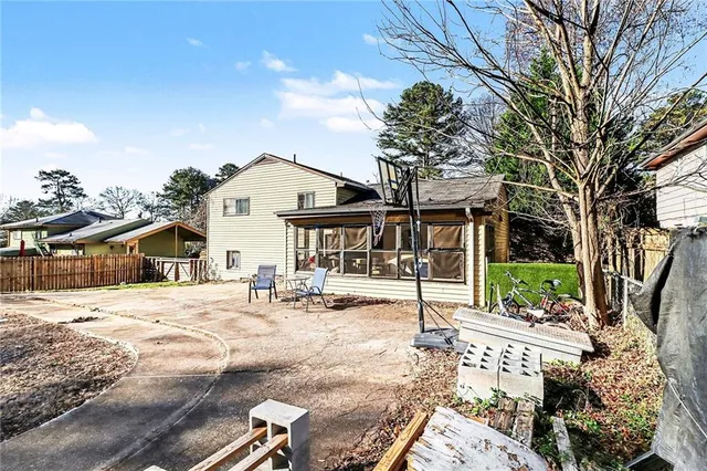 a front view of a house with a tree