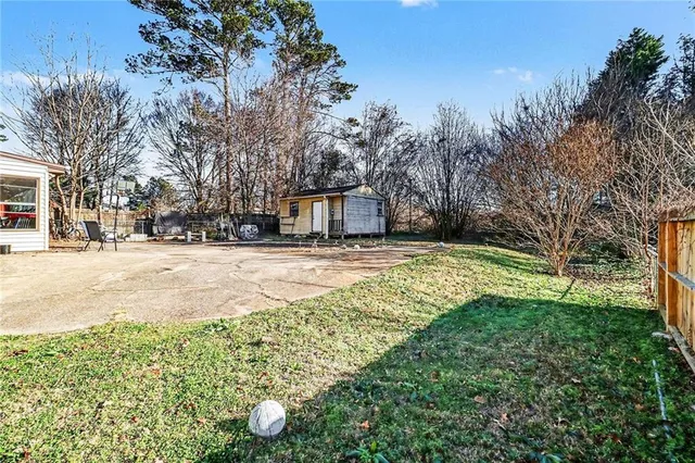a view of yard with swimming pool and green space