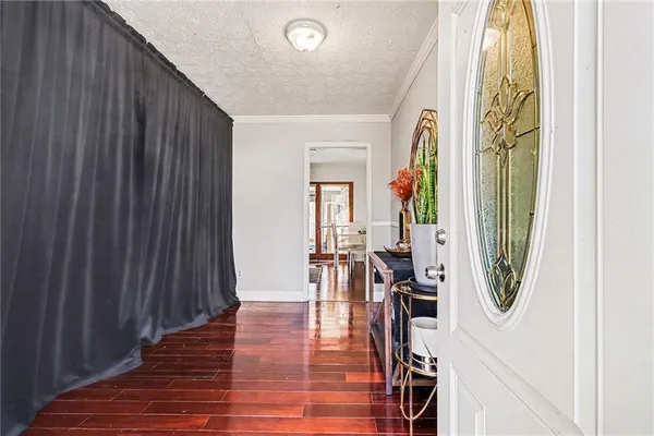 an entryway with wooden floor and stairs