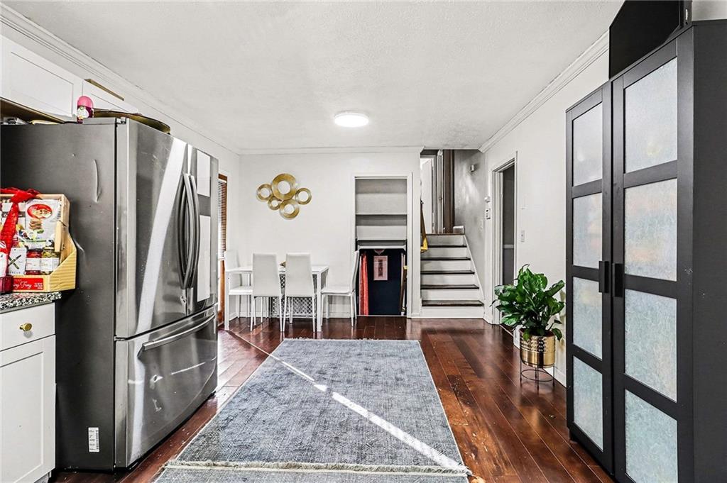 6186 Deans Way Morrow, GA 30260 - Photo 7 of 35 a kitchen with stainless steel appliances a refrigerator and wooden floor