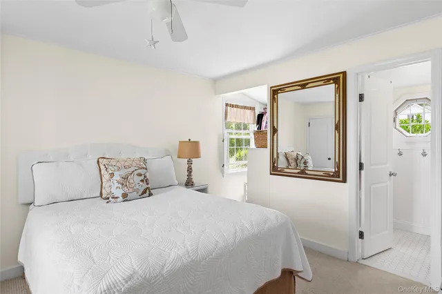 a bedroom with a bed and painting on the wall