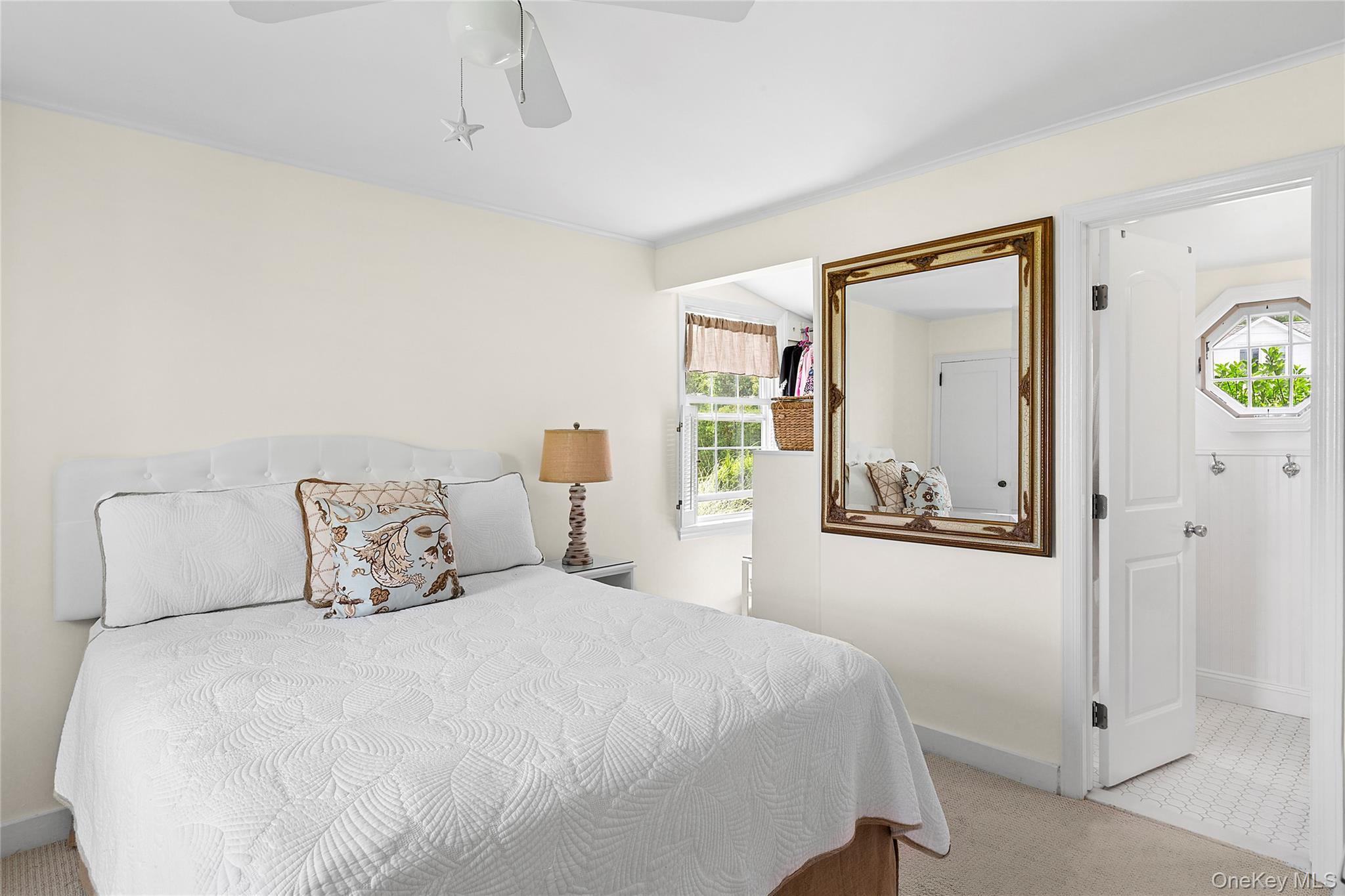 315 Old Salt Road Mattituck, NY 11952 - Photo 12 of 22 a bedroom with a bed and painting on the wall