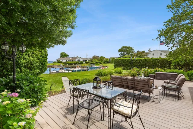 a patio with water view fountain and a dining table with garden view