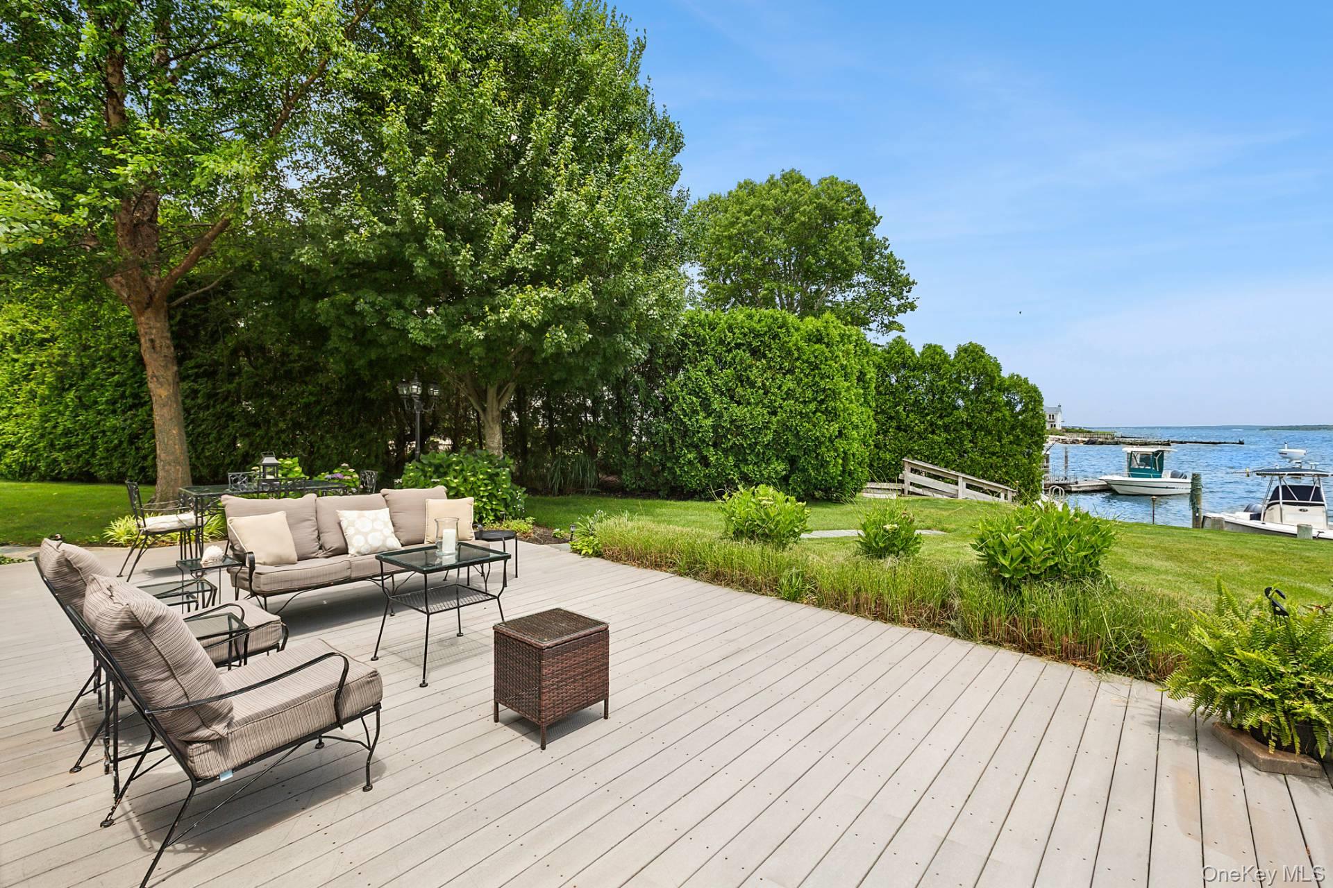 315 Old Salt Road Mattituck, NY 11952 - Photo 3 of 22 a view of a patio with couches and table and chairs next to yard