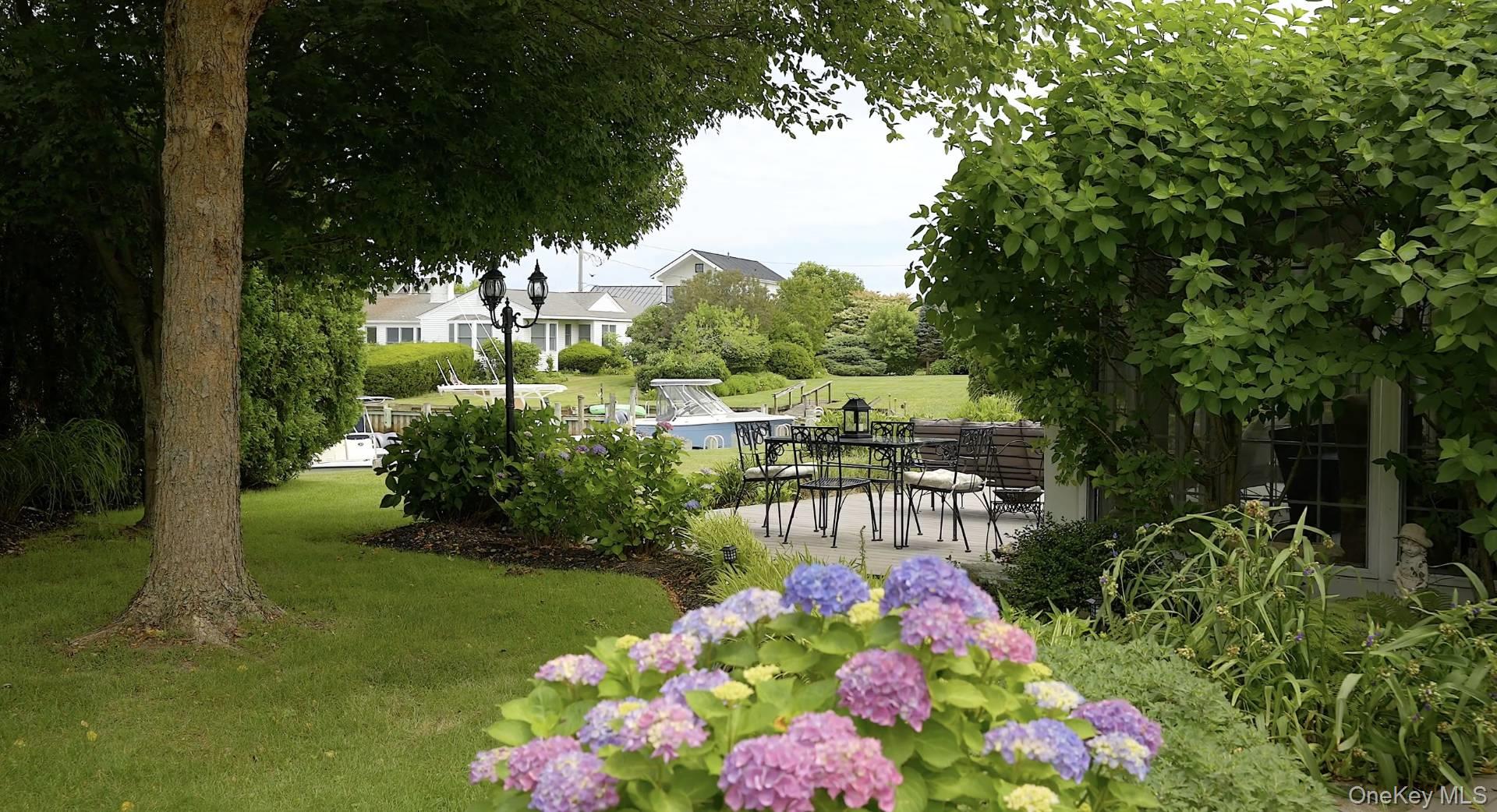 315 Old Salt Road Mattituck, NY 11952 - Photo 4 of 22 a view of a flower in a yard with potted plants