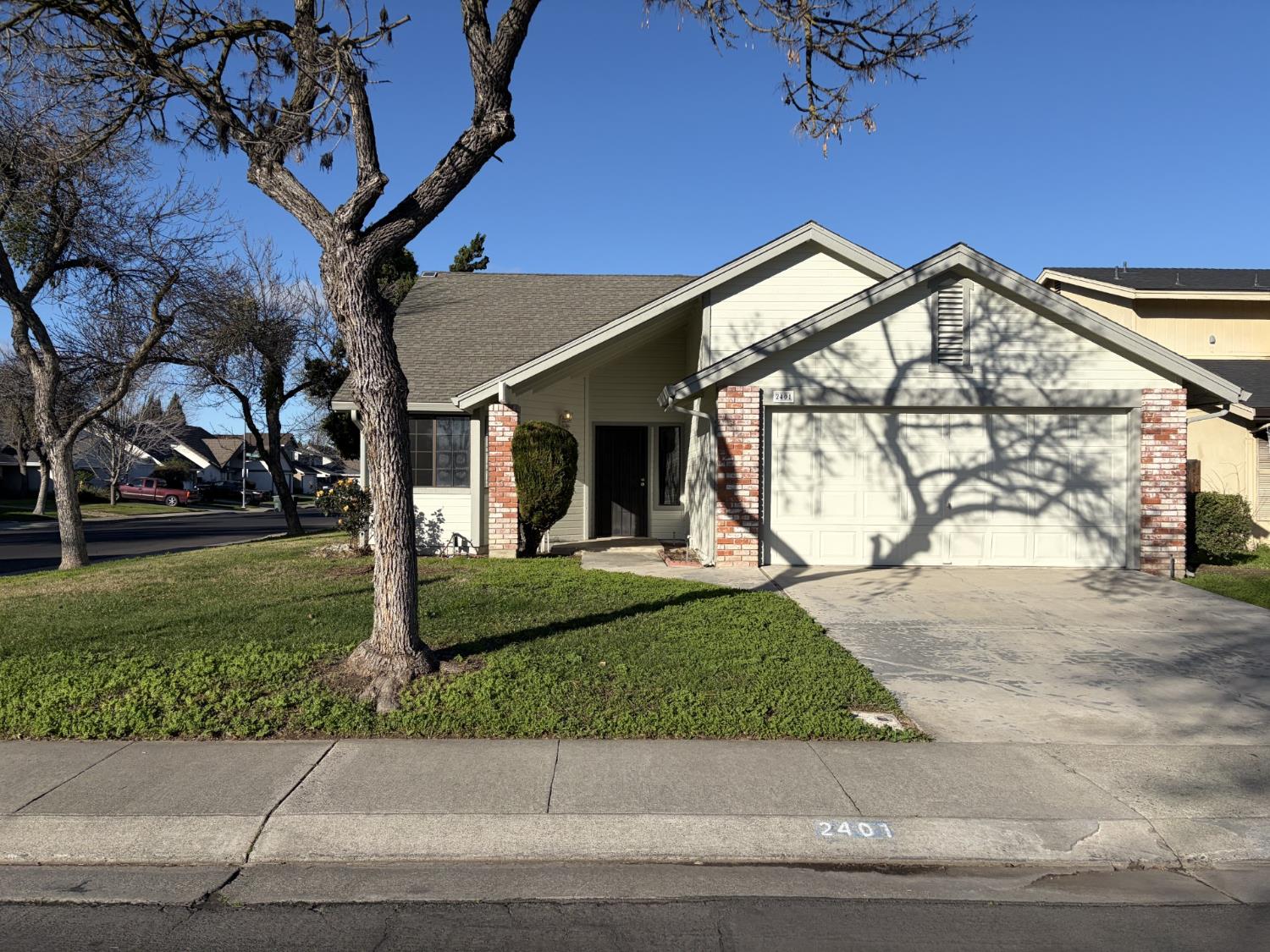 2401 Walnut Grove Way Modesto, CA 95355 - Photo 1 of 25 a view of a house with a yard and pathway
