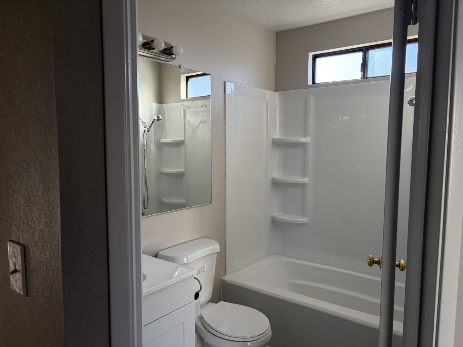 2401 Walnut Grove Way Modesto, CA 95355 - Photo 15 of 25 a bathroom with a toilet and a shower