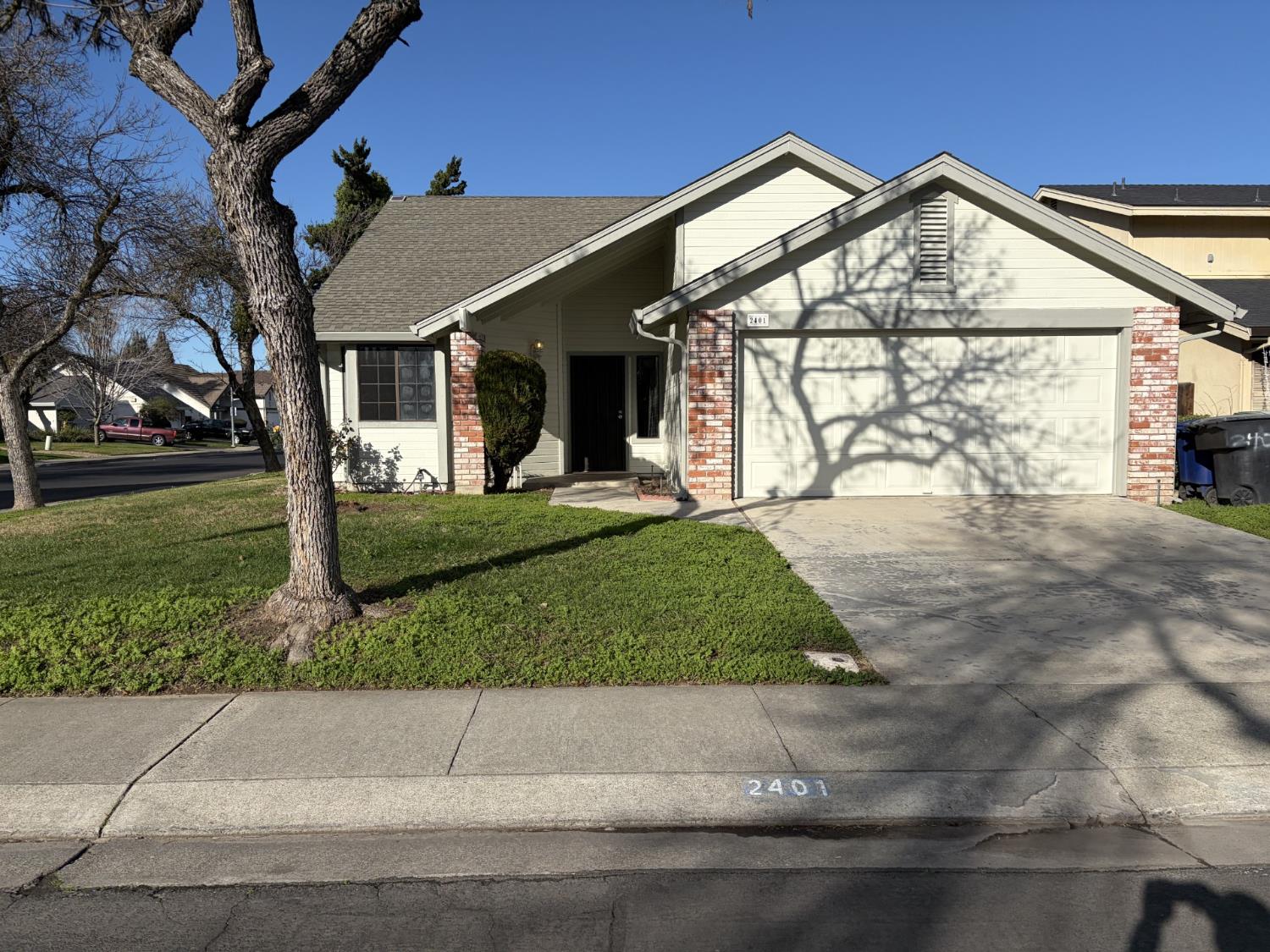 2401 Walnut Grove Way Modesto, CA 95355 - Photo 25 of 25 a front view of a house with garden