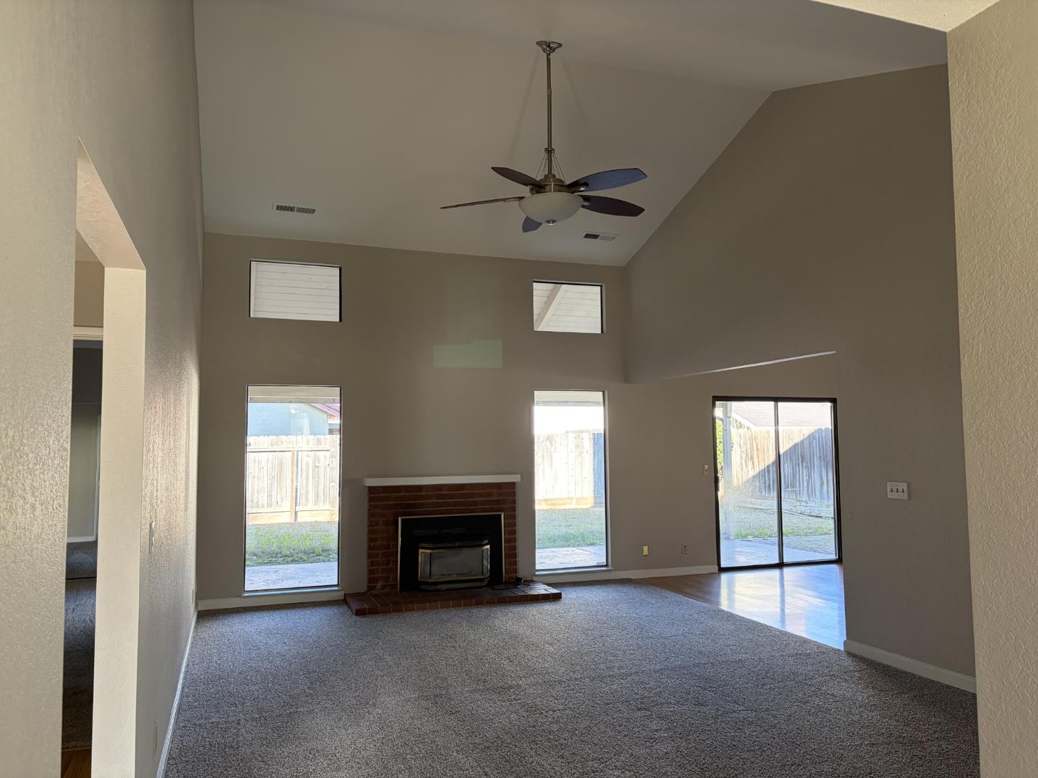 2401 Walnut Grove Way Modesto, CA 95355 - Photo 6 of 25 a view of an empty room with a fireplace and a window