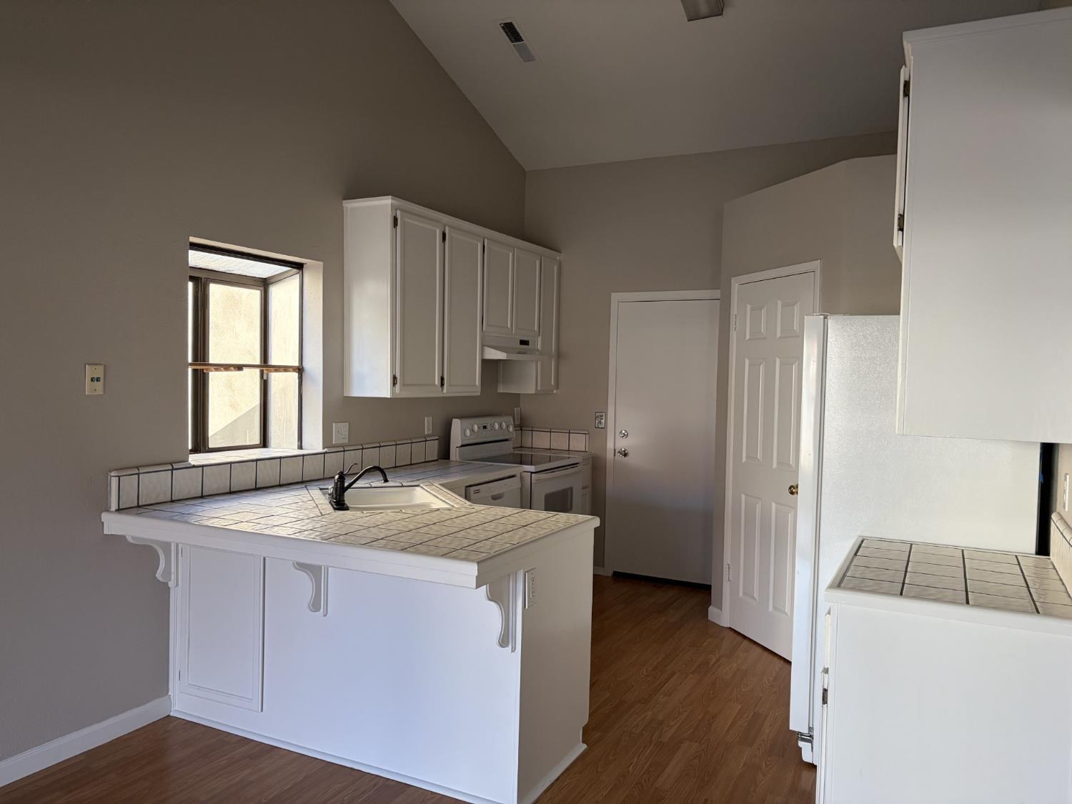 2401 Walnut Grove Way Modesto, CA 95355 - Photo 7 of 25 a kitchen with a sink stove and refrigerator