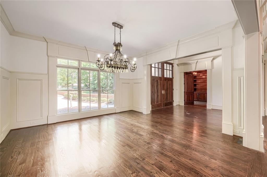 7965 Robin Road Cumming, GA 30041 - Photo 19 of 64 a view of a big room with wooden floor chandeliers and kitchen