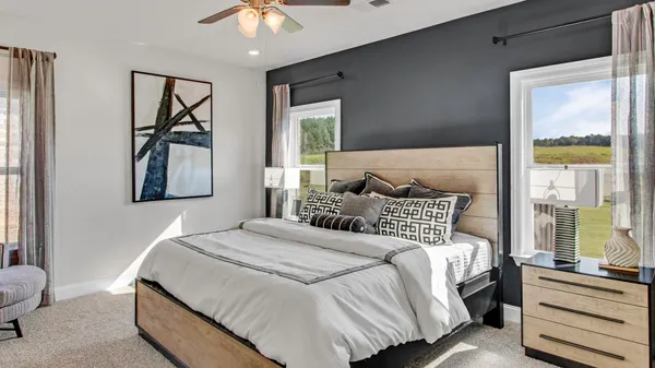 a bedroom with a bed and a painting on the wall