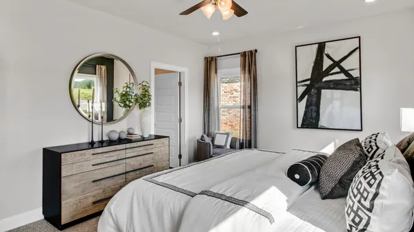 a bedroom with a bed and a mirror