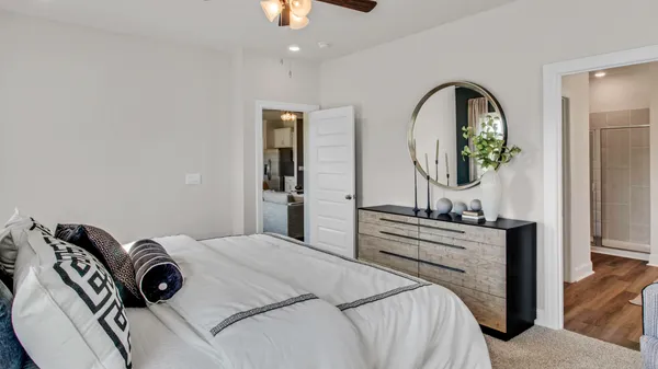 a bedroom with a bed and a dresser