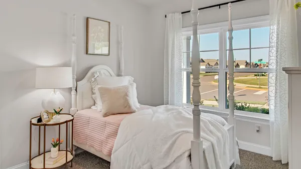 a bedroom with a bed and a painting on the wall