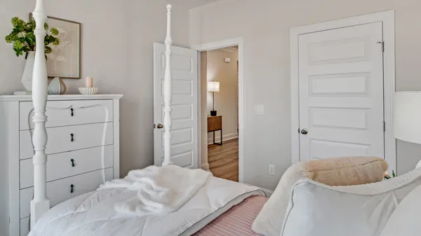 a bedroom with a bed and a dresser