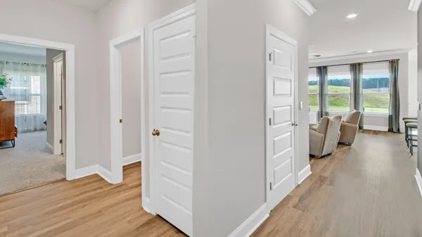 a view of a livingroom with wooden floor and furniture