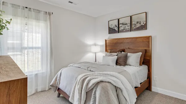 a bed room with a bed and a window