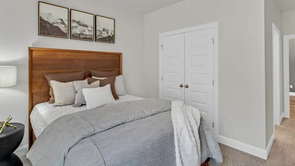 a bedroom with a bed and a window