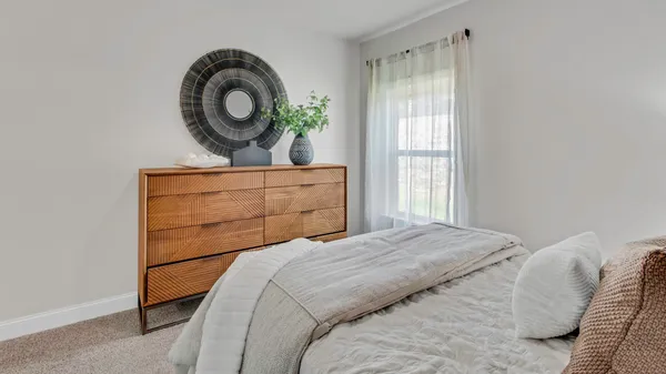 a bathroom with a granite countertop toilet sink and mirror