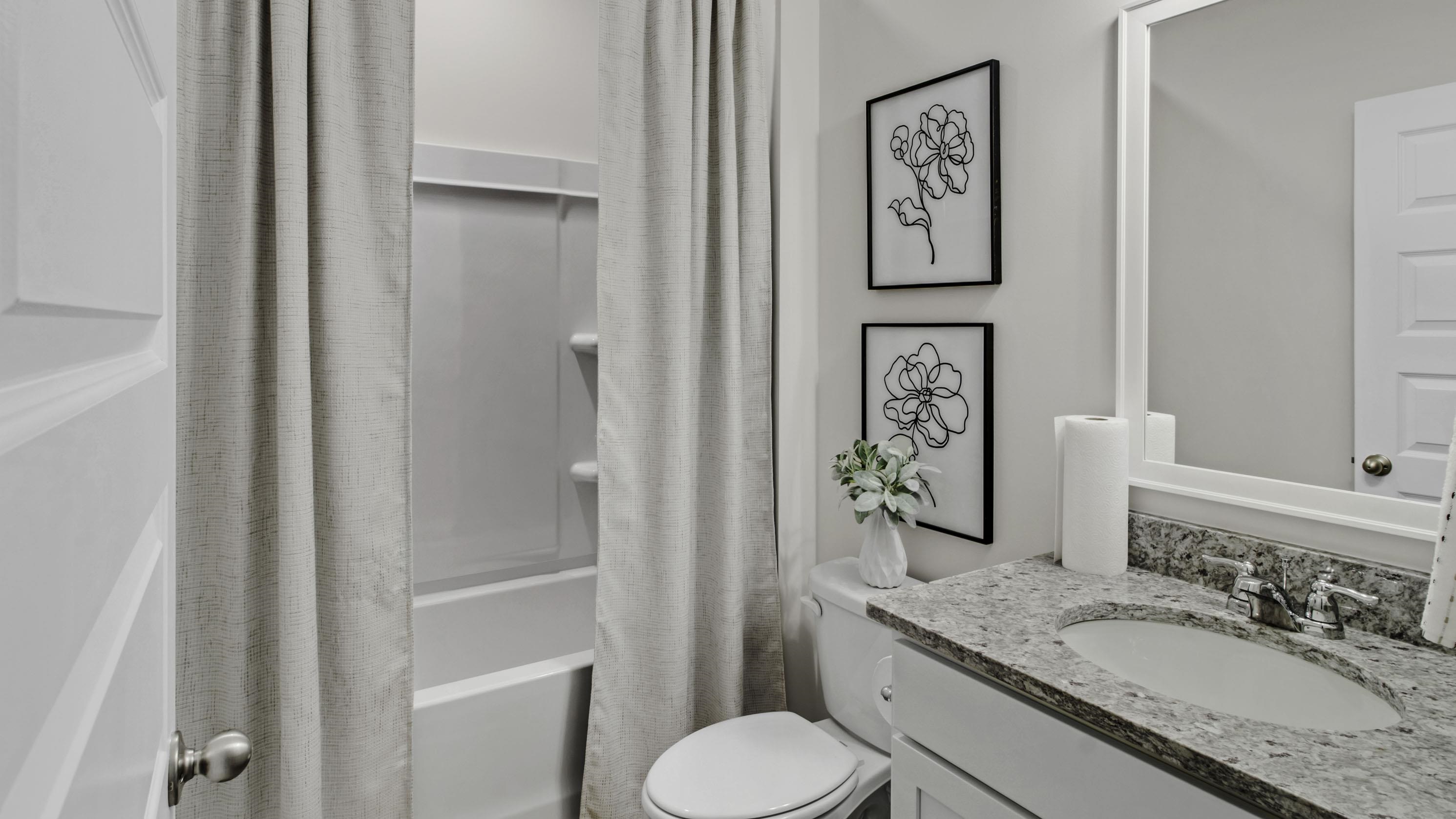 1010 Mewborn Farm Road Oakland, TN 38060 - Photo 32 of 40 a bathroom with a granite countertop toilet sink and mirror