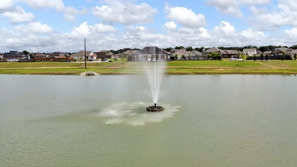 a view of a swimming pool with a yard and a porch