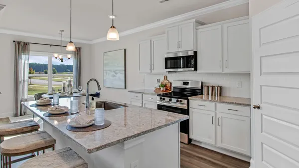 a kitchen with sink and cabinets