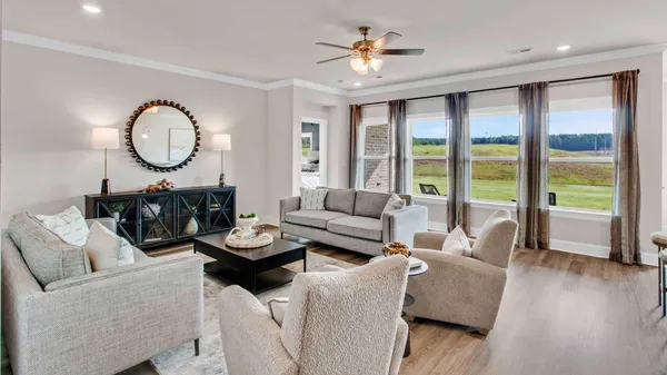 a living room with furniture a table and a large window