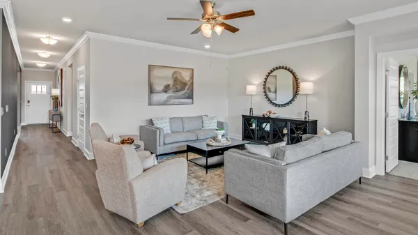 a living room with fireplace furniture and a wooden floor