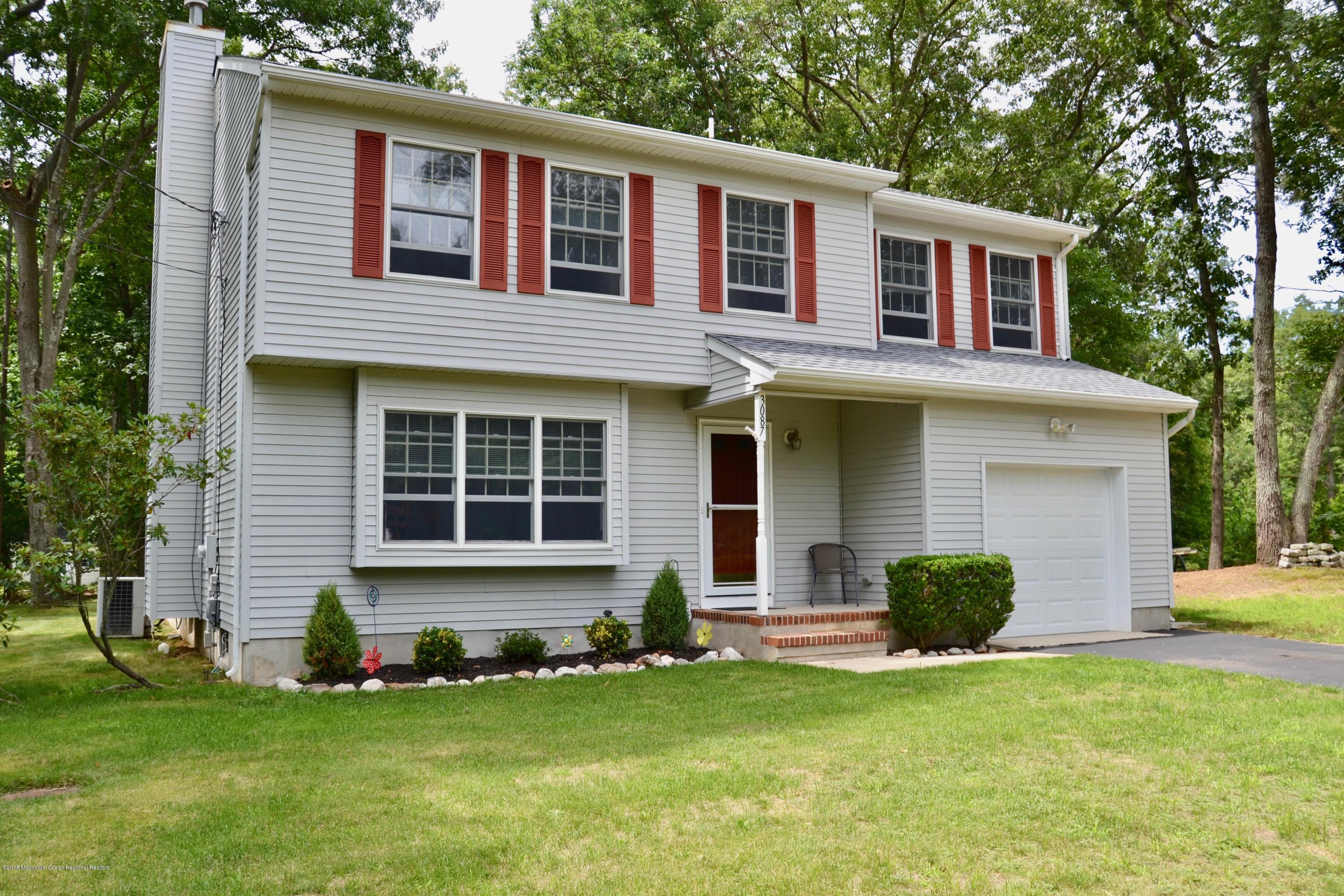 3087 Ridgeway Boulevard Manchester Township, NJ 08759 - Photo 1 of 30 a front view of a house with a yard and garage