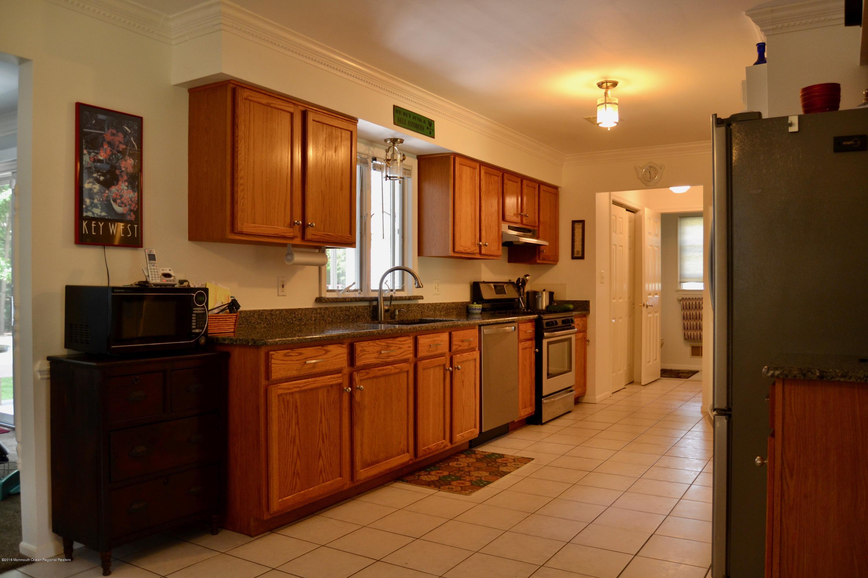 3087 Ridgeway Boulevard Manchester Township, NJ 08759 - Photo 15 of 30 a kitchen with stainless steel appliances granite countertop a refrigerator and a sink