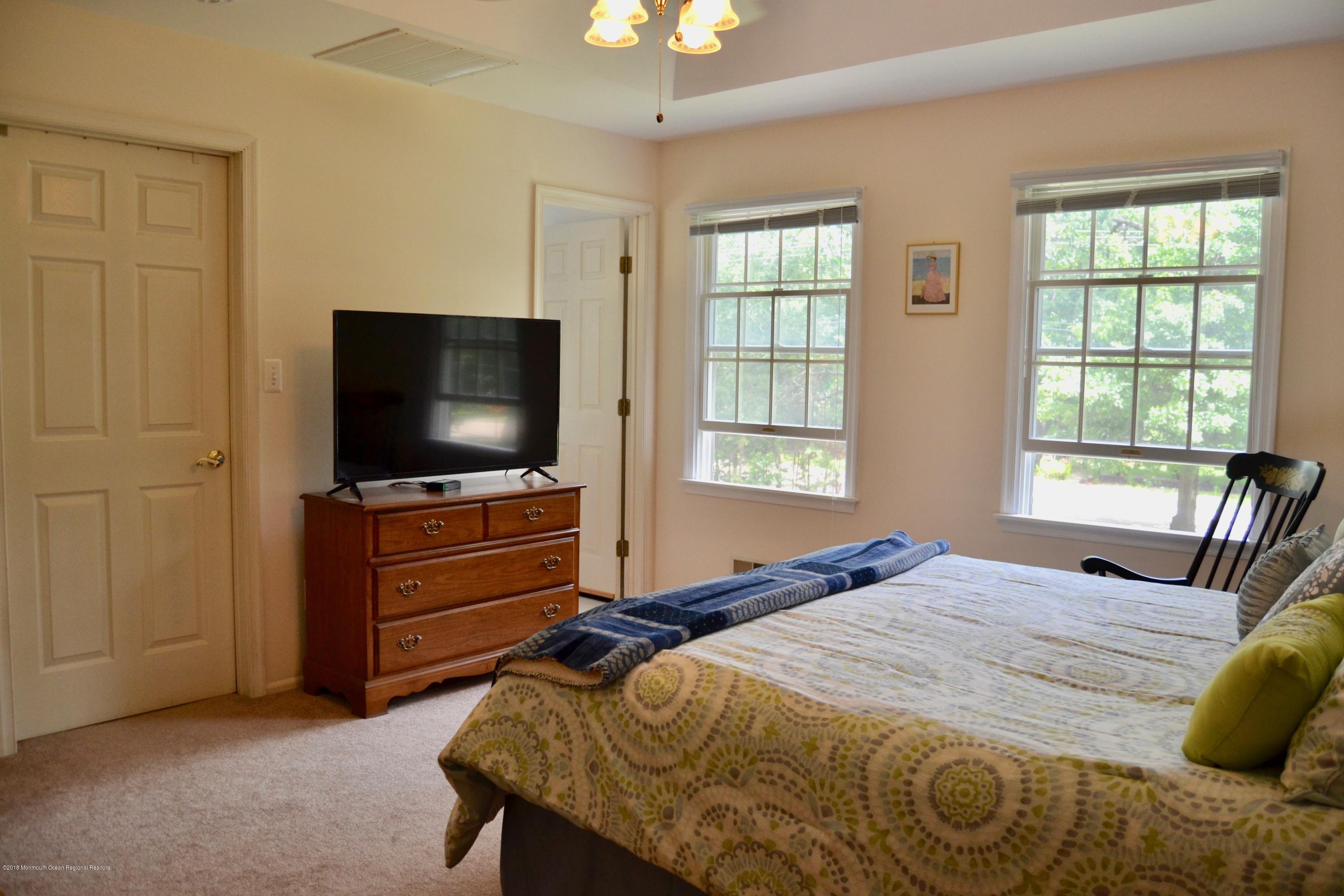 3087 Ridgeway Boulevard Manchester Township, NJ 08759 - Photo 21 of 30 a bedroom with a bed and a flat screen tv