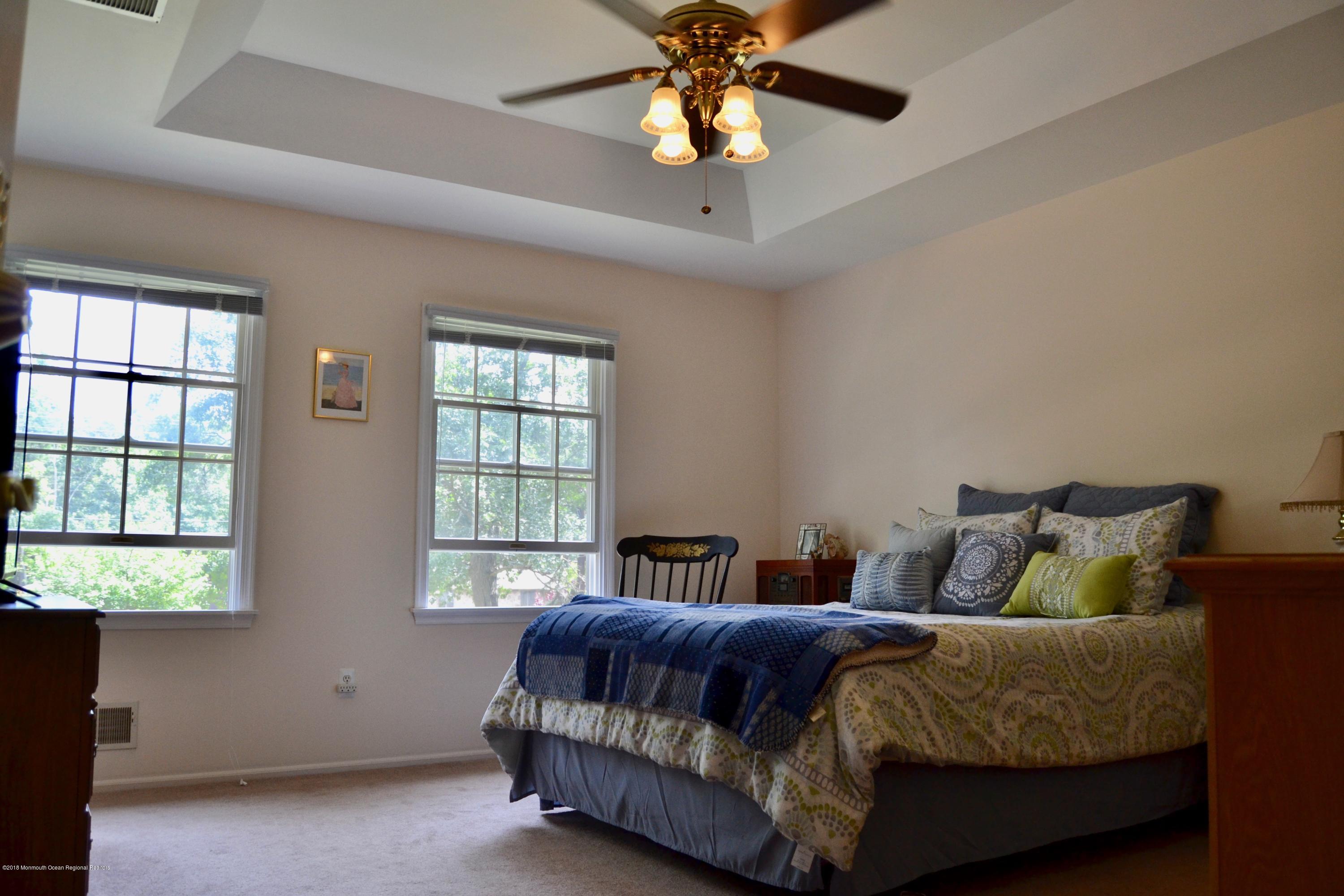 3087 Ridgeway Boulevard Manchester Township, NJ 08759 - Photo 22 of 30 a spacious bedroom with a bed and window