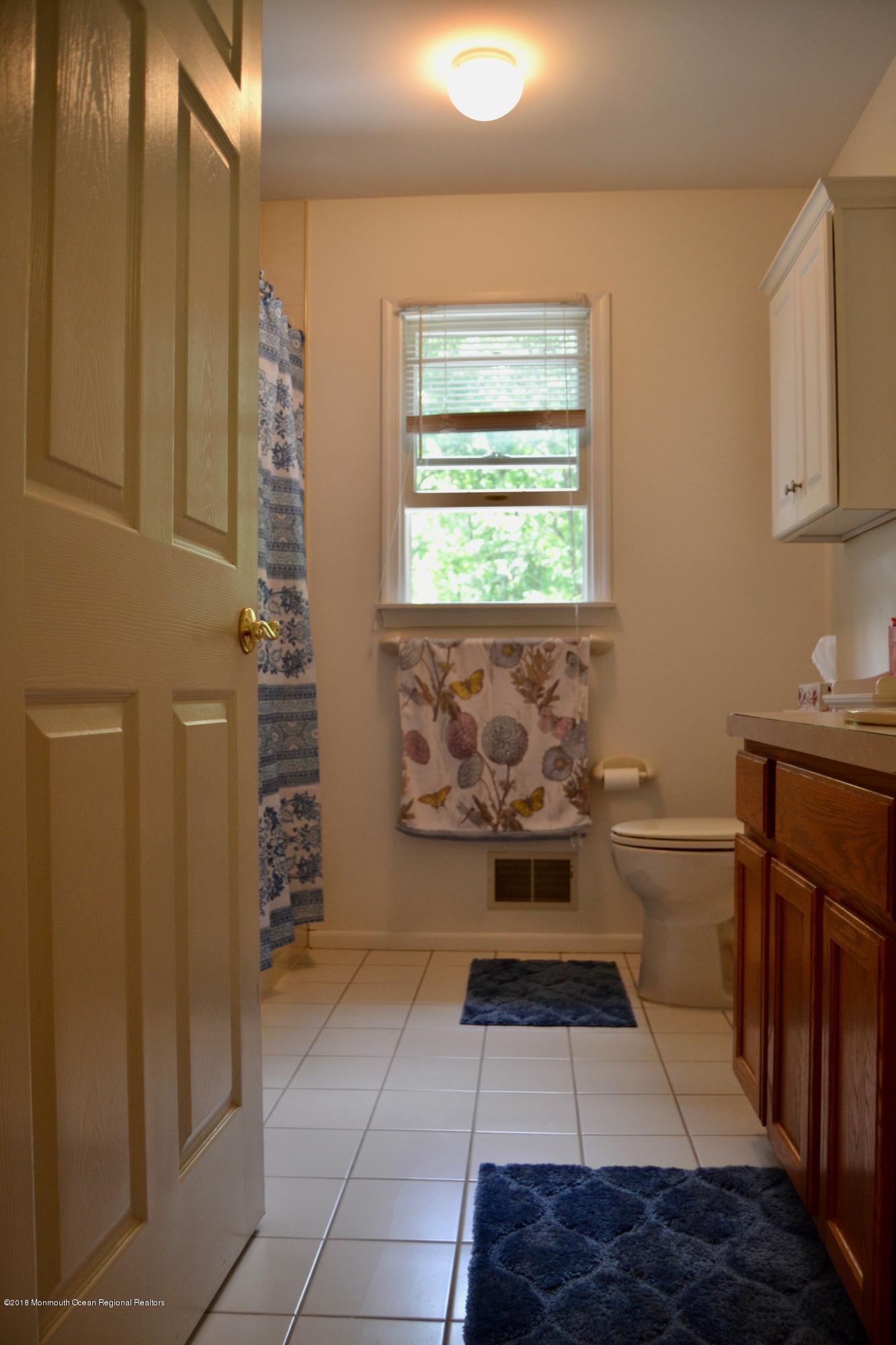 3087 Ridgeway Boulevard Manchester Township, NJ 08759 - Photo 27 of 30 a bathroom with a toilet a sink and a mirror